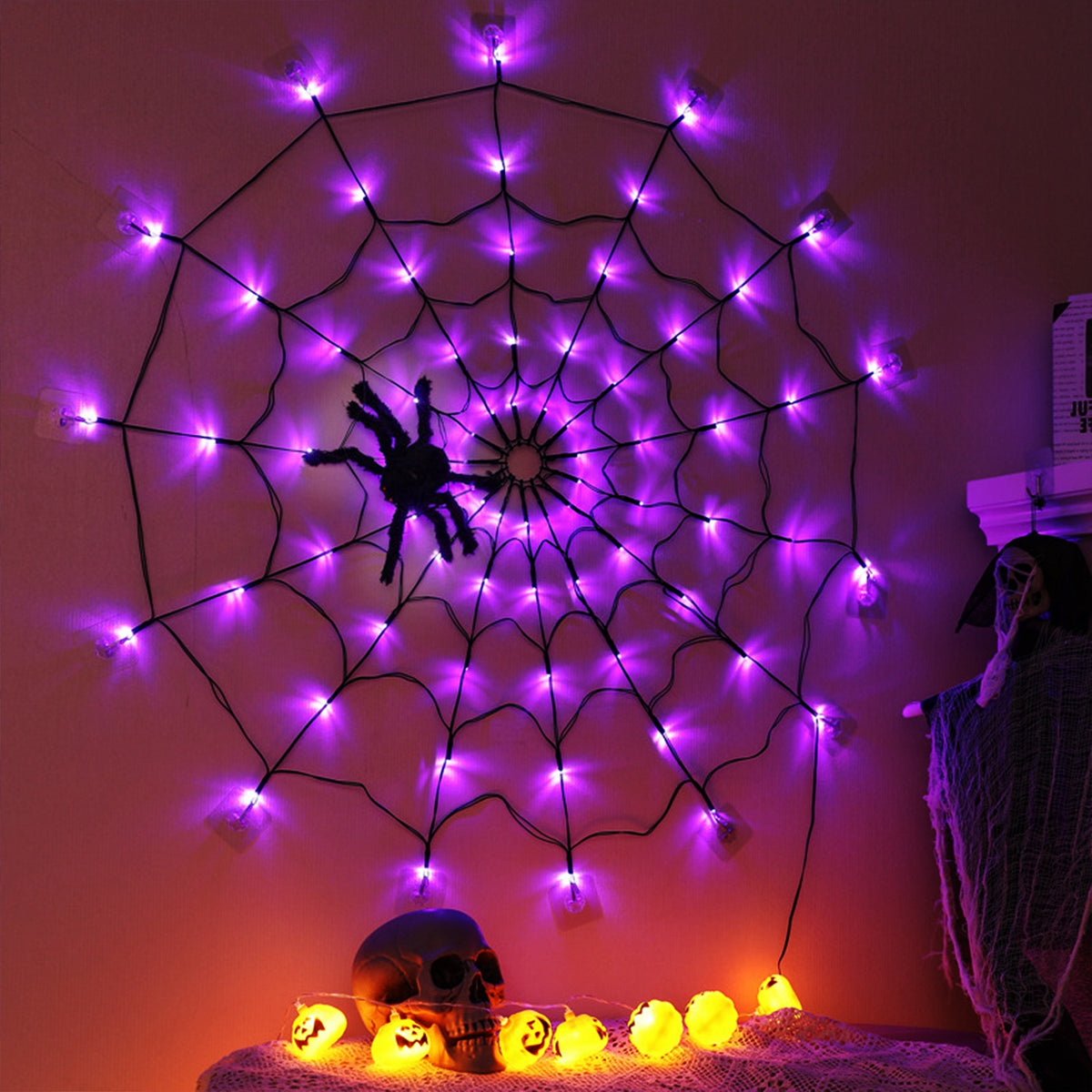 Warm yellow lit Halloween spider web decoration at night