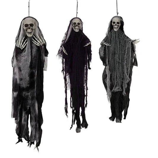 Three hanging skeleton grim reaper ghosts on a porch at night